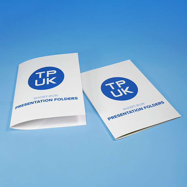Pair of custom short run printed presentation folders by TradePrintingUK.com on a blue background, displaying white folders with prominent blue TPUK logo and Short Run Presentation Folders text, one open to showcase interior capacity and the other closed for a professional stackable view, suitable for organising documents in business or event settings.