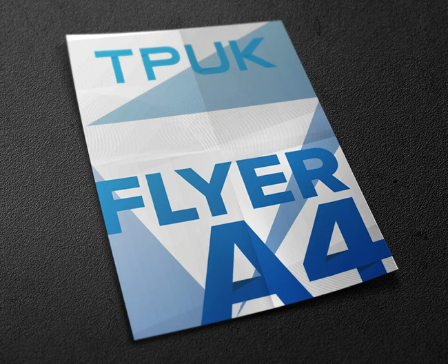 Custom printed A5 flyers and leaflets by TradePrintingUK.com fanned out on a white background